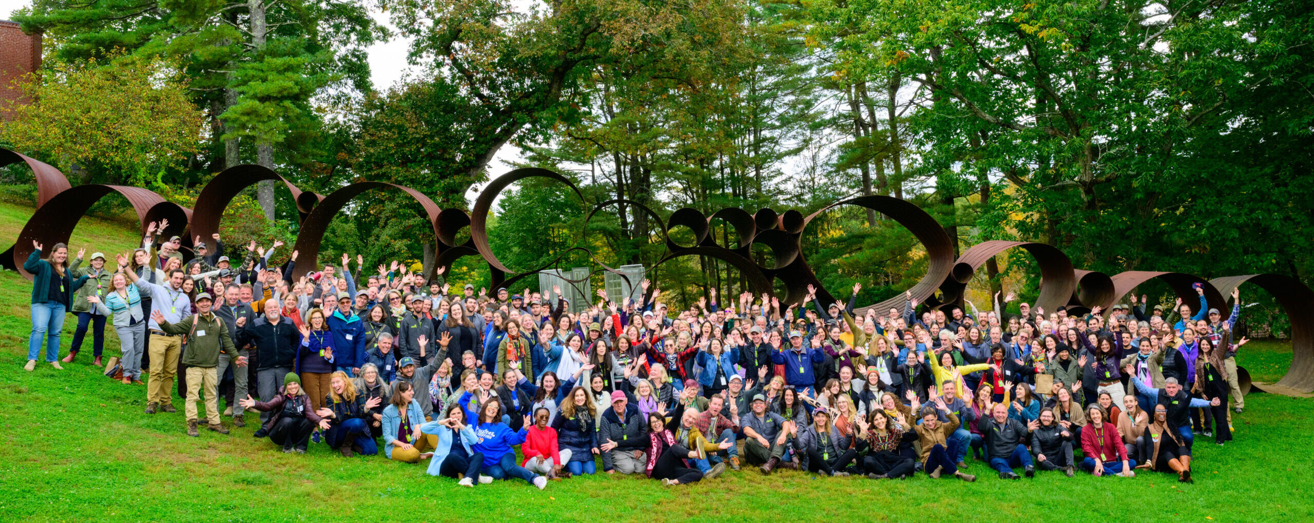 All 2023 staff pose for a group photo next to Lincoln sculpture at deCordova Sculpture Park and Museum