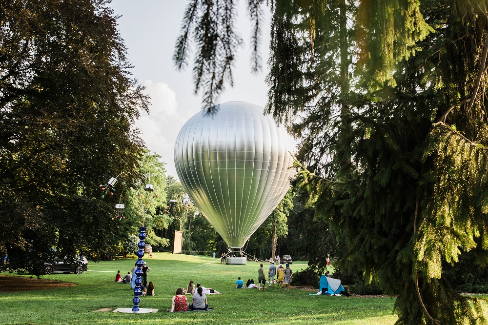 a shiny balloon among sculptures outside