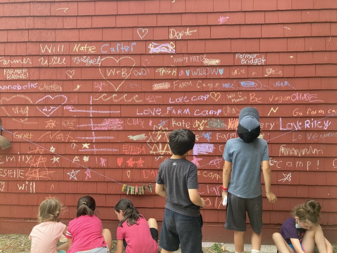 A group of campers making chalk wall art at Weir River Farm Summer Camp