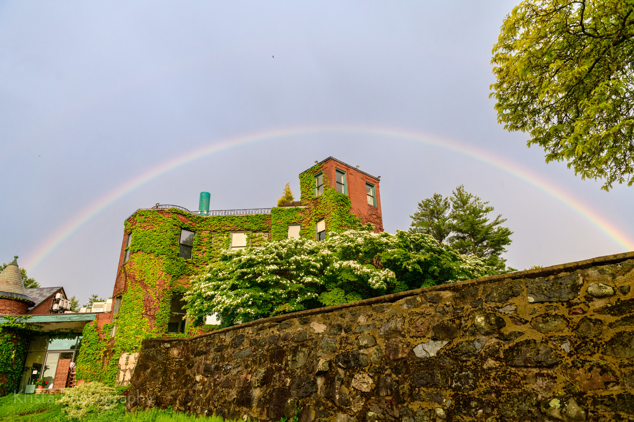 a rainbow over a brick building