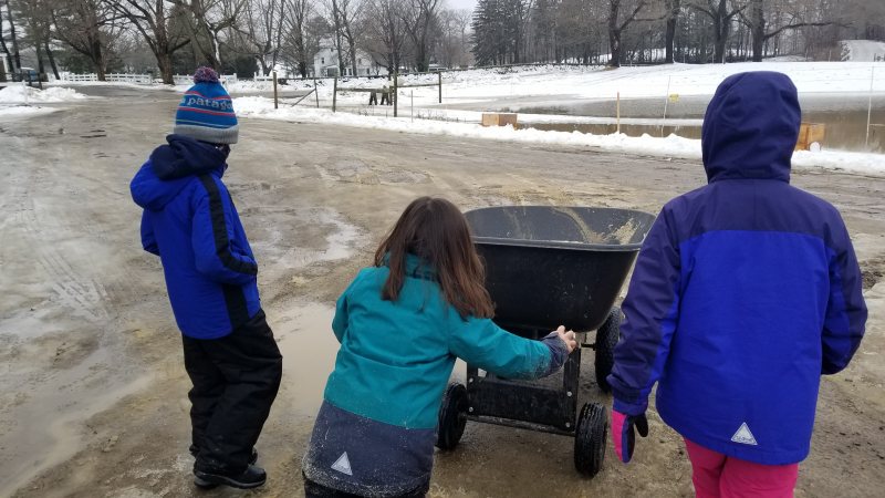 Child pushing wheelbarrow