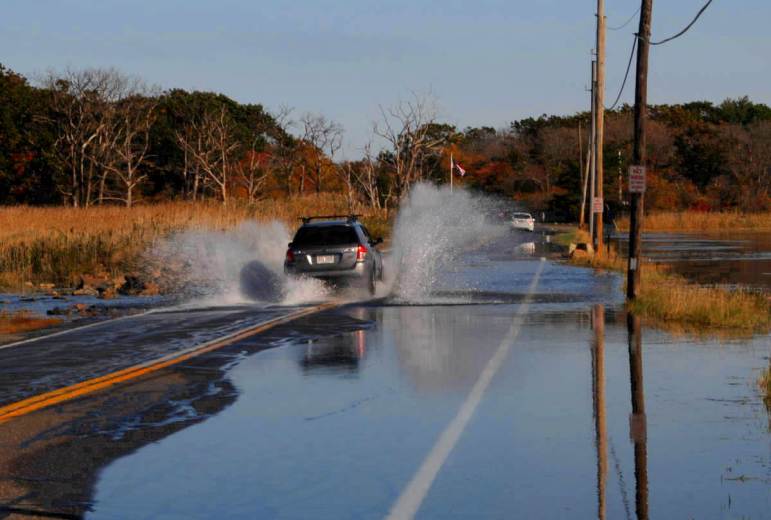 A car splashes through high water
