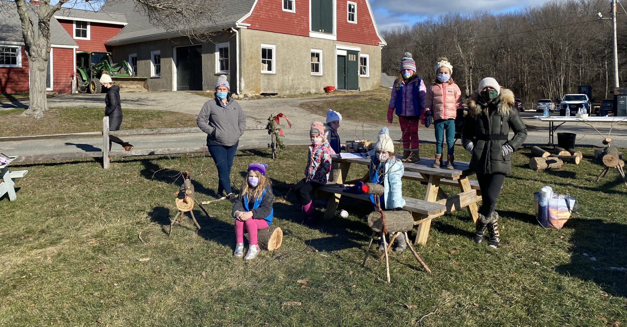 Participants in Reindeer Quest outdoors with reindeer statues at a Trustees farm