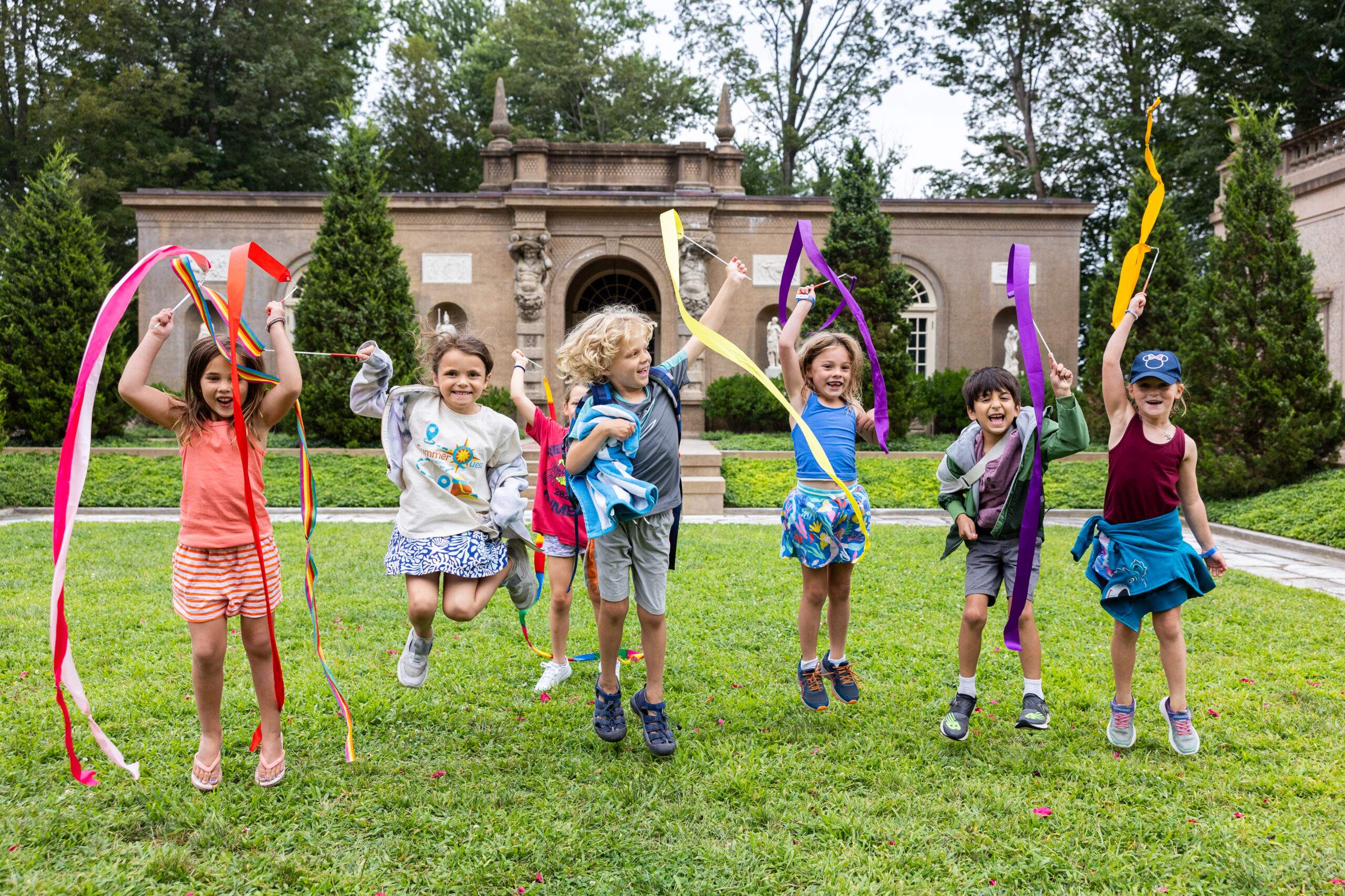 Campers playing with ribbons at the Crane Estate outdoors during Summerquest