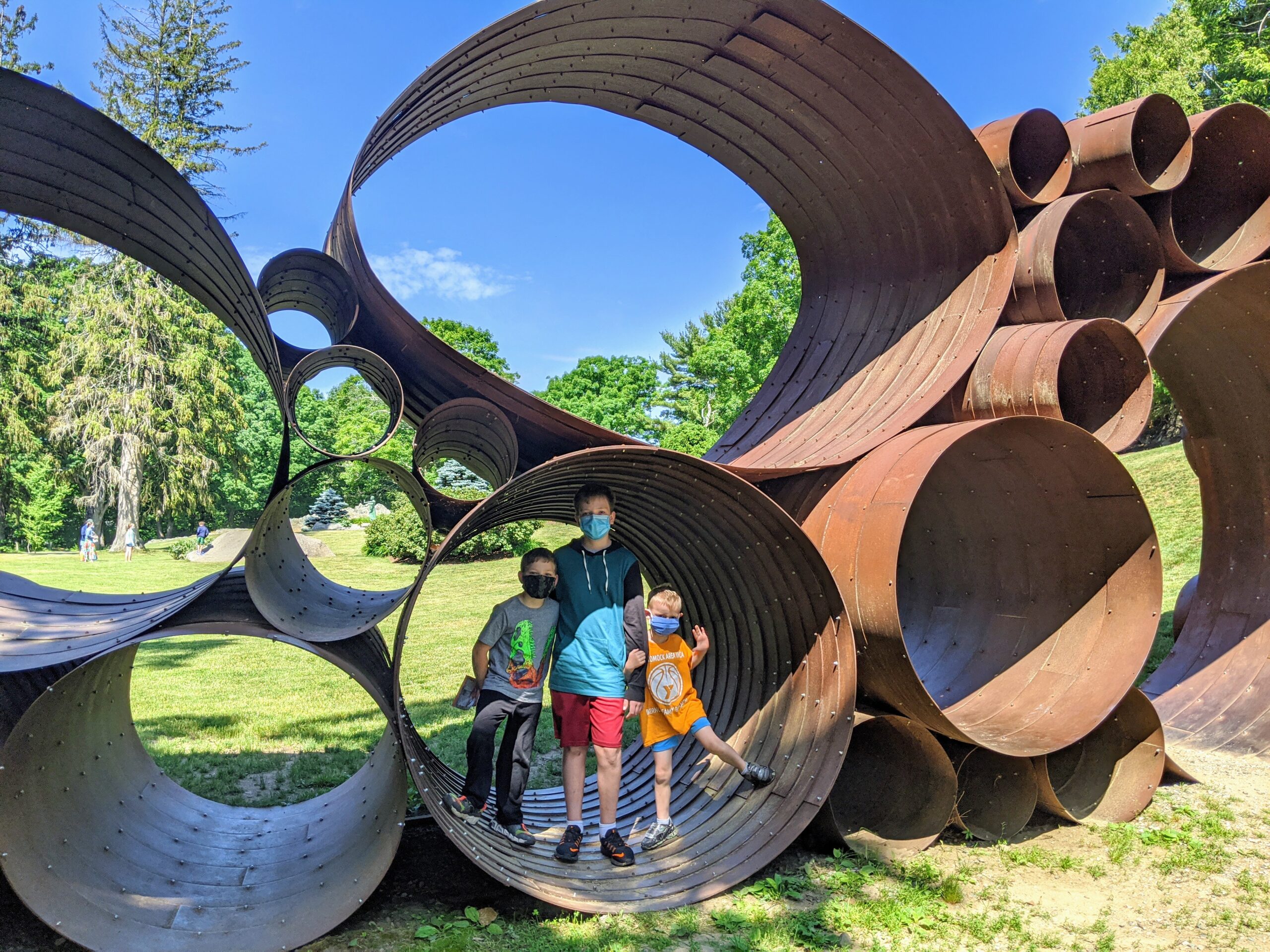 three young children play at deCordova Sculpture Park and Museum