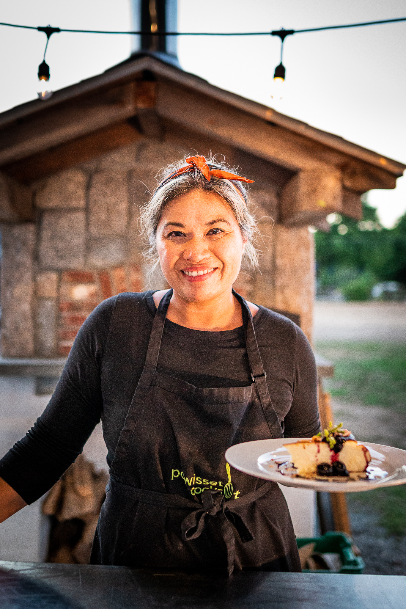 Chef Thi Bowles smiles at the camera with a dish she created