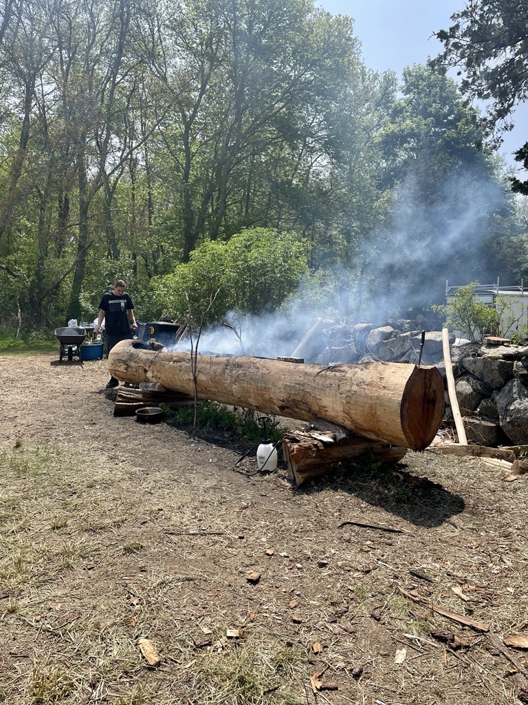 community members oversee the burnout of a traditional mishoon