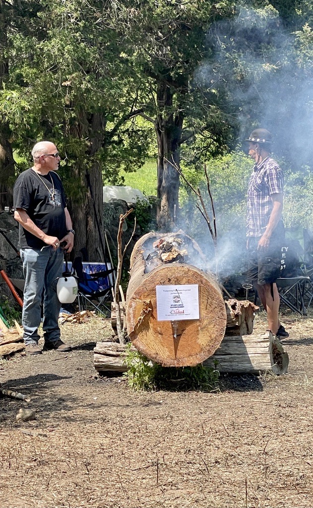 Community members oversee the burn out of a traditional mishoon