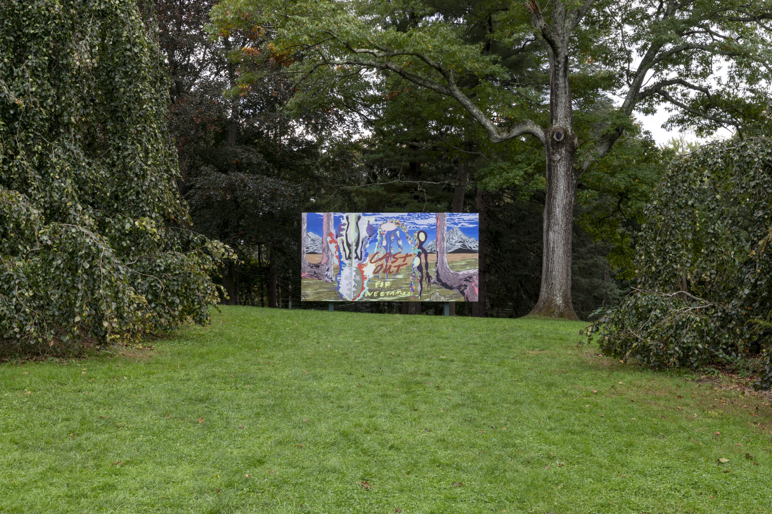 a vibrant artwork on a large billboard in a green park