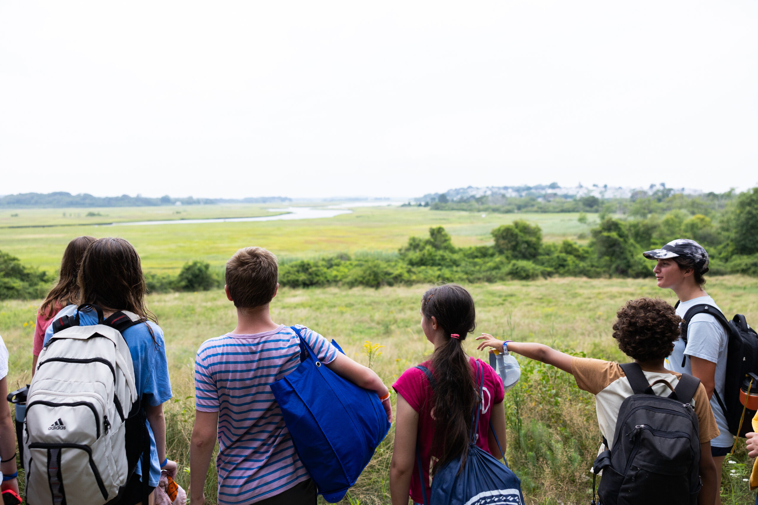 A small group of Summerquest campers looking out over the marshes at Crane Wildlife Refuge