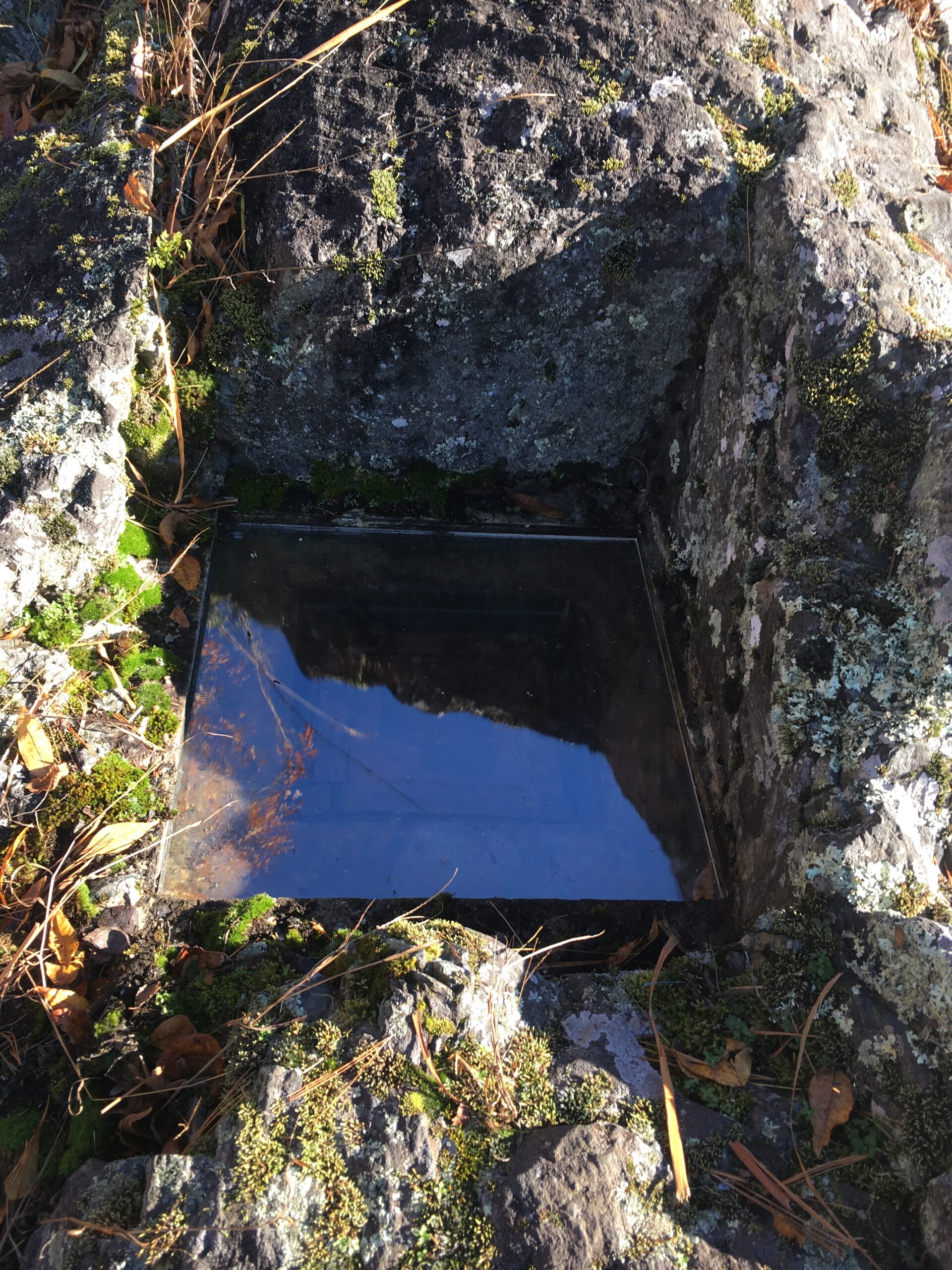 a clear box buried inside the stony ground