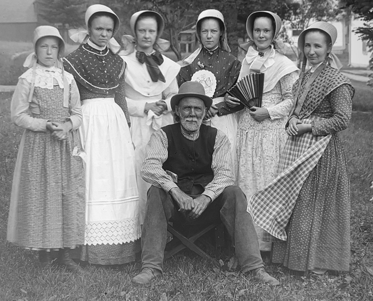 A black and white image of Shaker women and one non shaker man