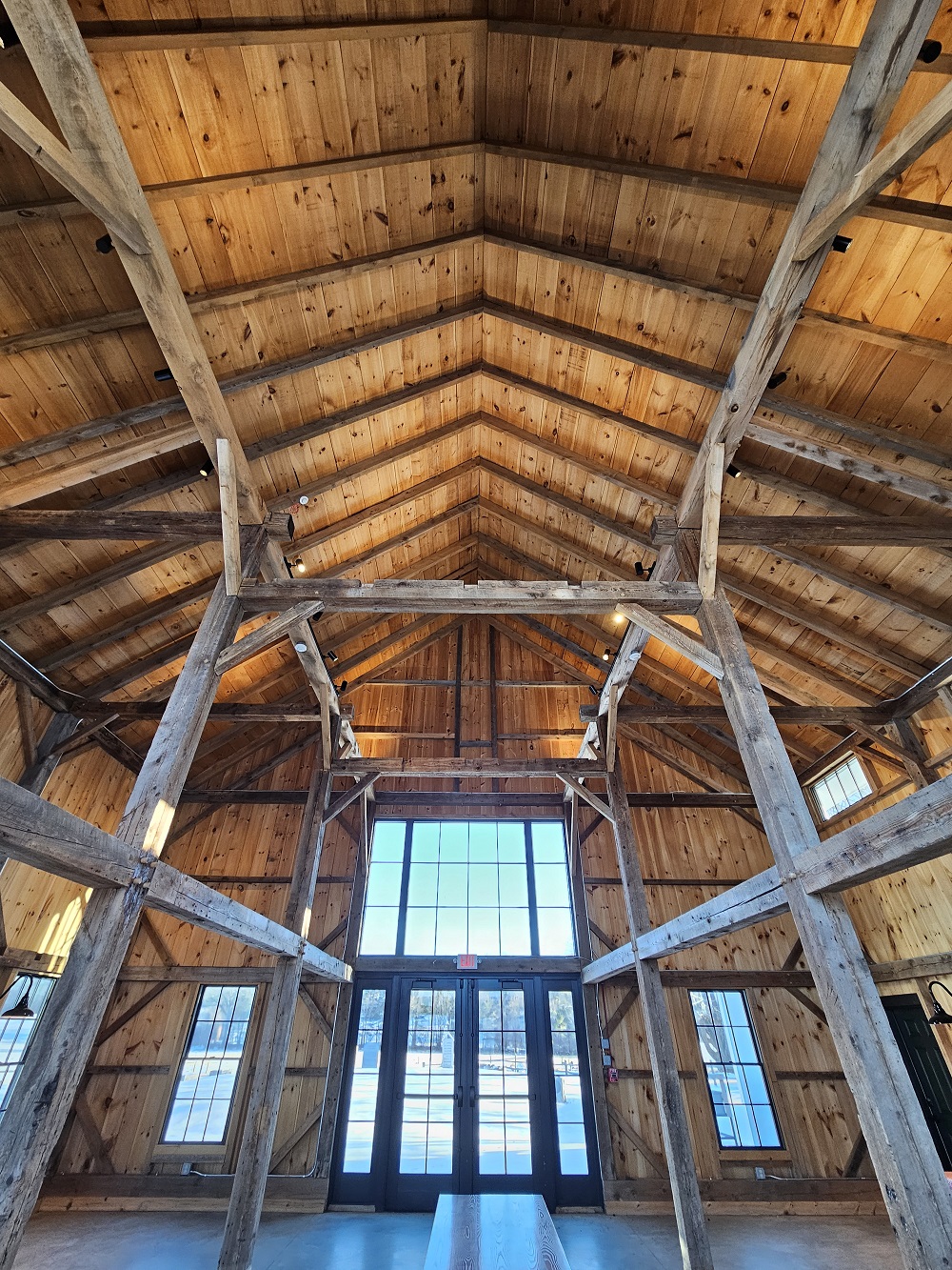 the ceiling of a wooden post and beam barn
