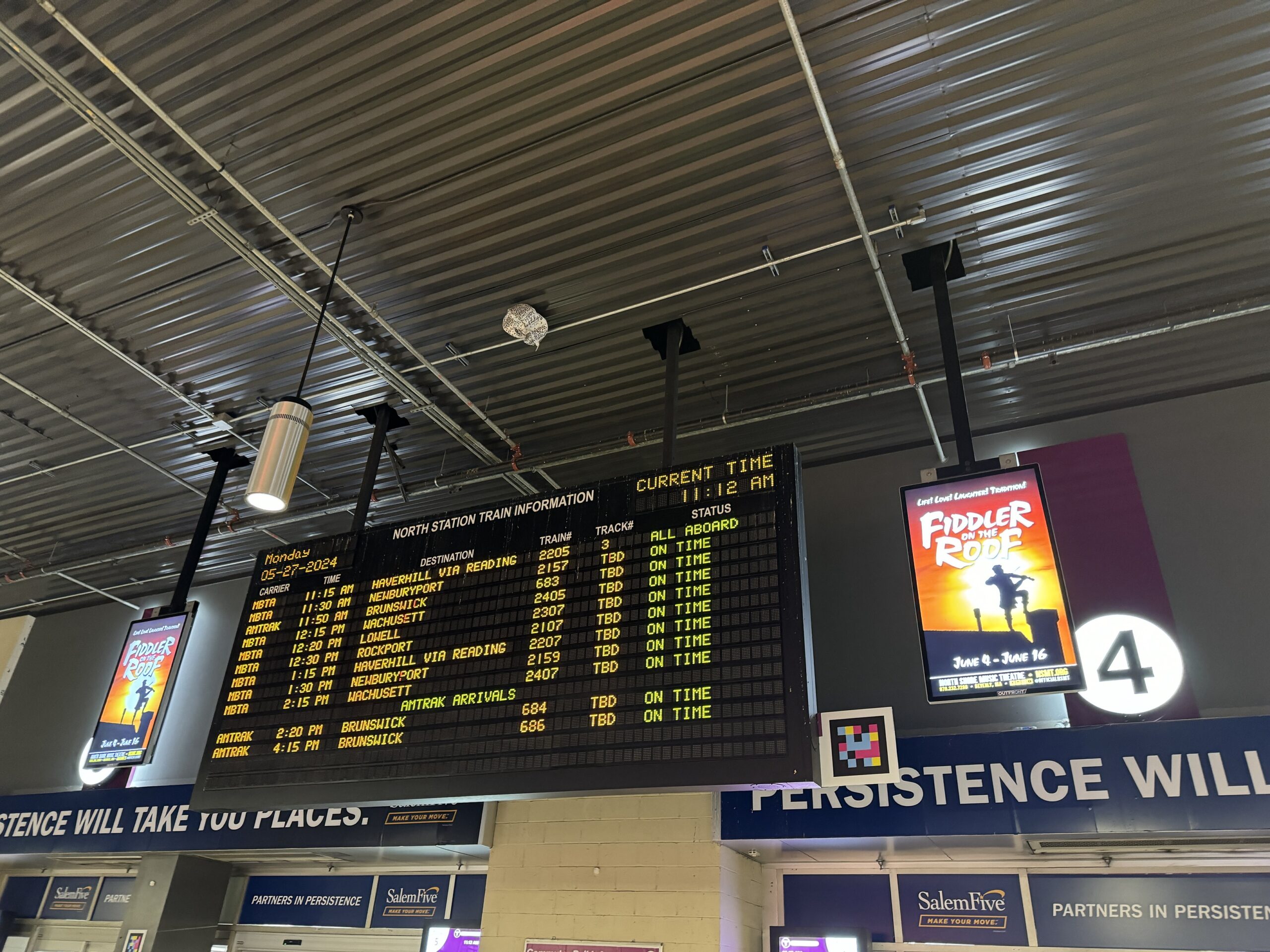 A train board displays arrivals and departures at Boston's North Station.