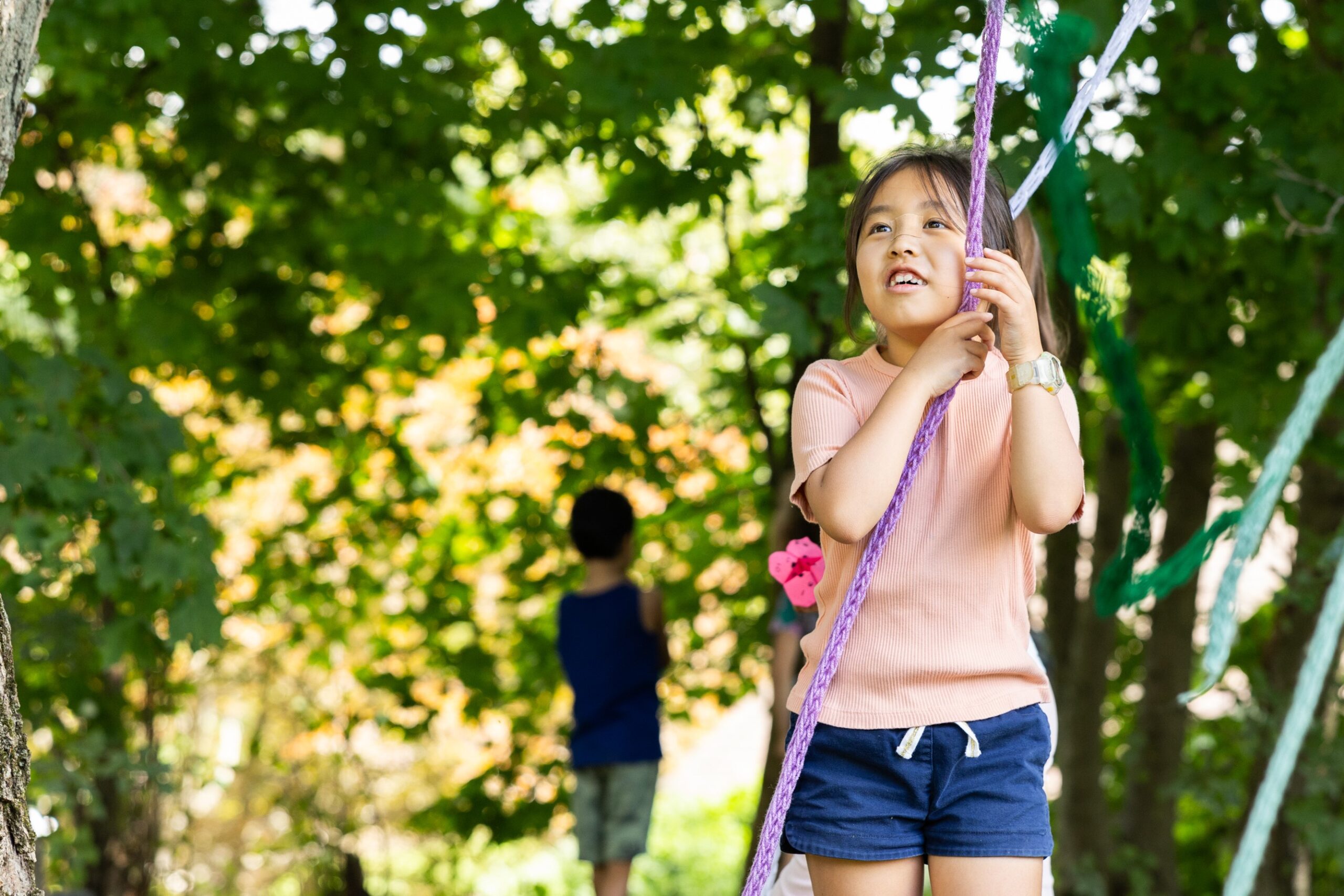 A summer camp participant hands rope at deCordova Sculpture Park and Museum.