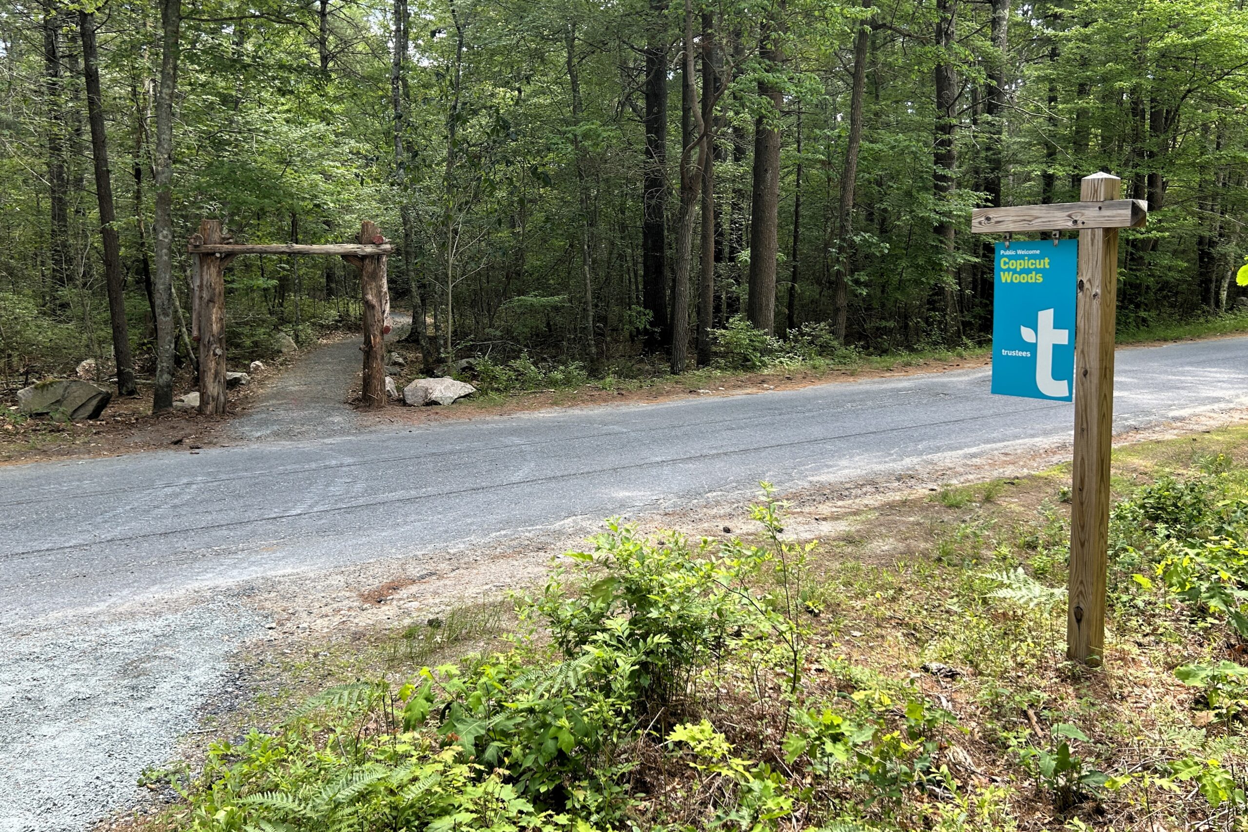 View of the Discovery Trail entrance from the parking lot at Copicut Woods in Fall River