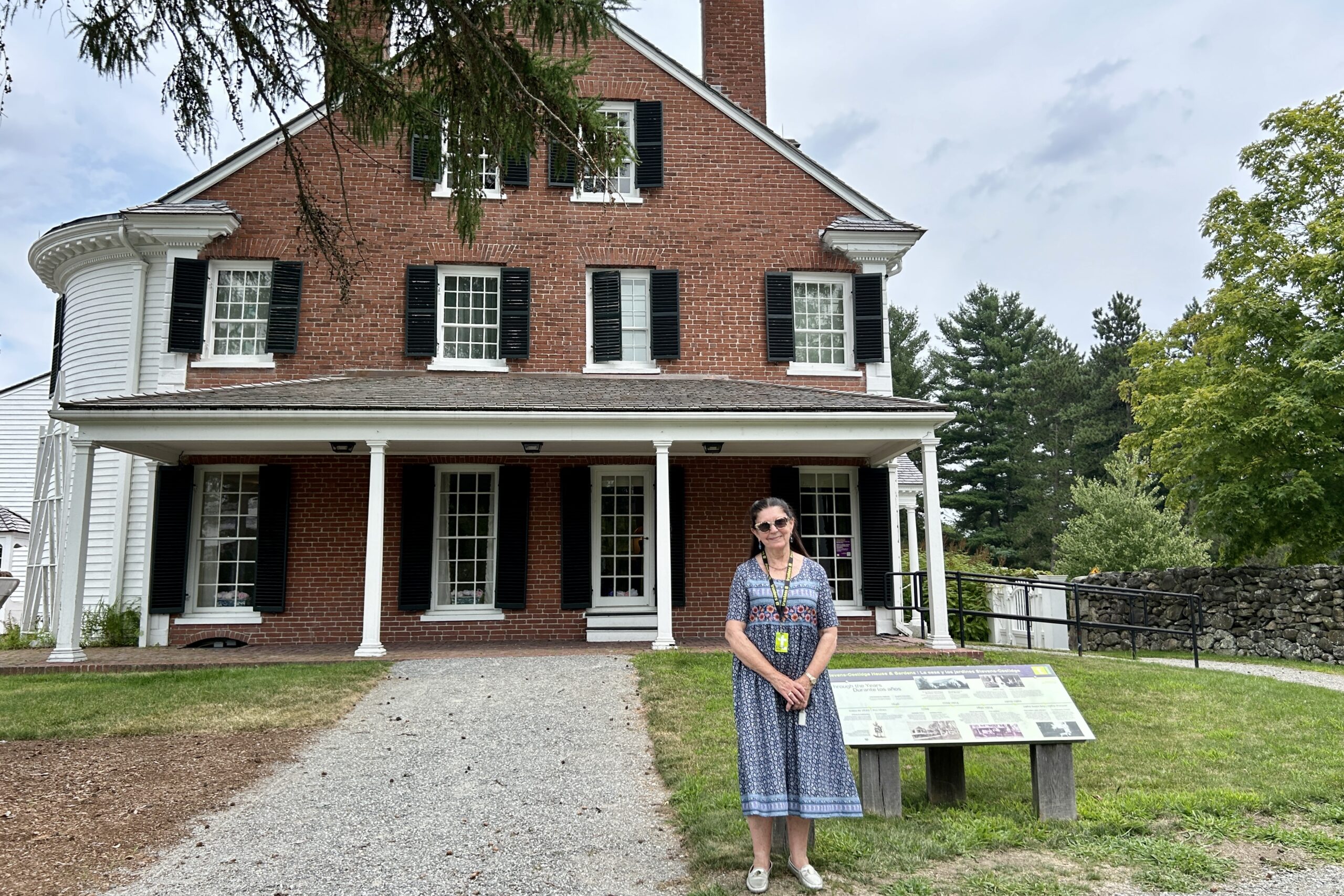 Vanessa Parminger, Trustees House Interpreter, stands in in front of the historic house at Stevens-Coolidge House & Gardens.