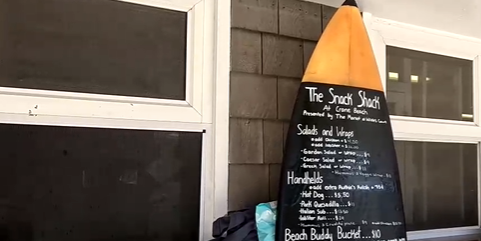 A surfboard acts as a menu board at Crane Beach