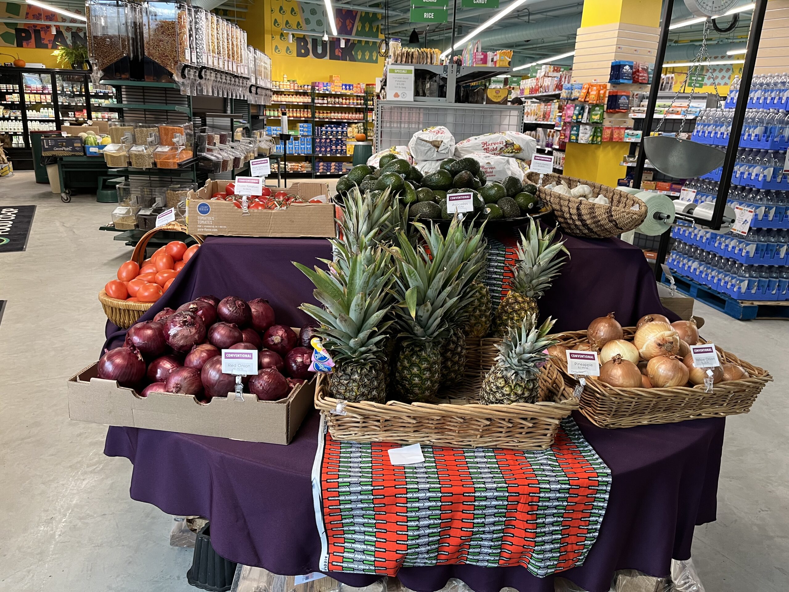 pineapples, onions, and other produce arranged on a table