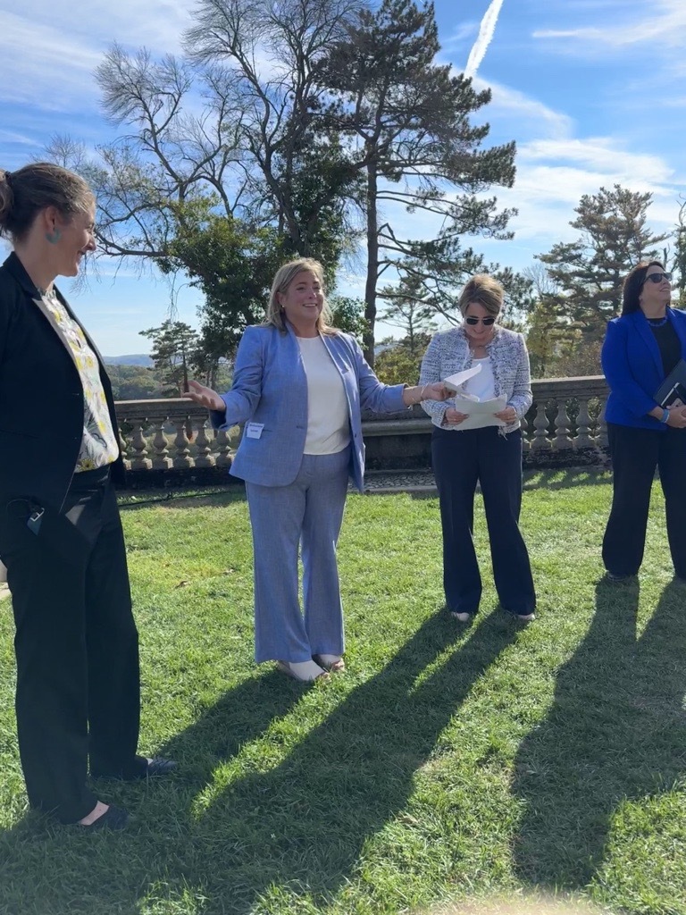 Four women including Gov Maura Healey and Lt Gov Kim Driscoll stand outside the Great House at Castle Hill