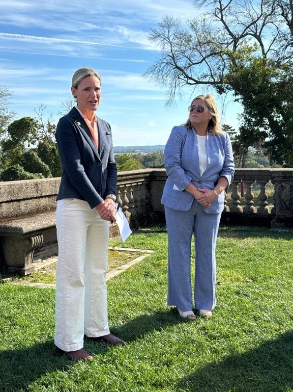 CEO Katie Theoharides gives remarks standing outside the Great House at Castle Hill