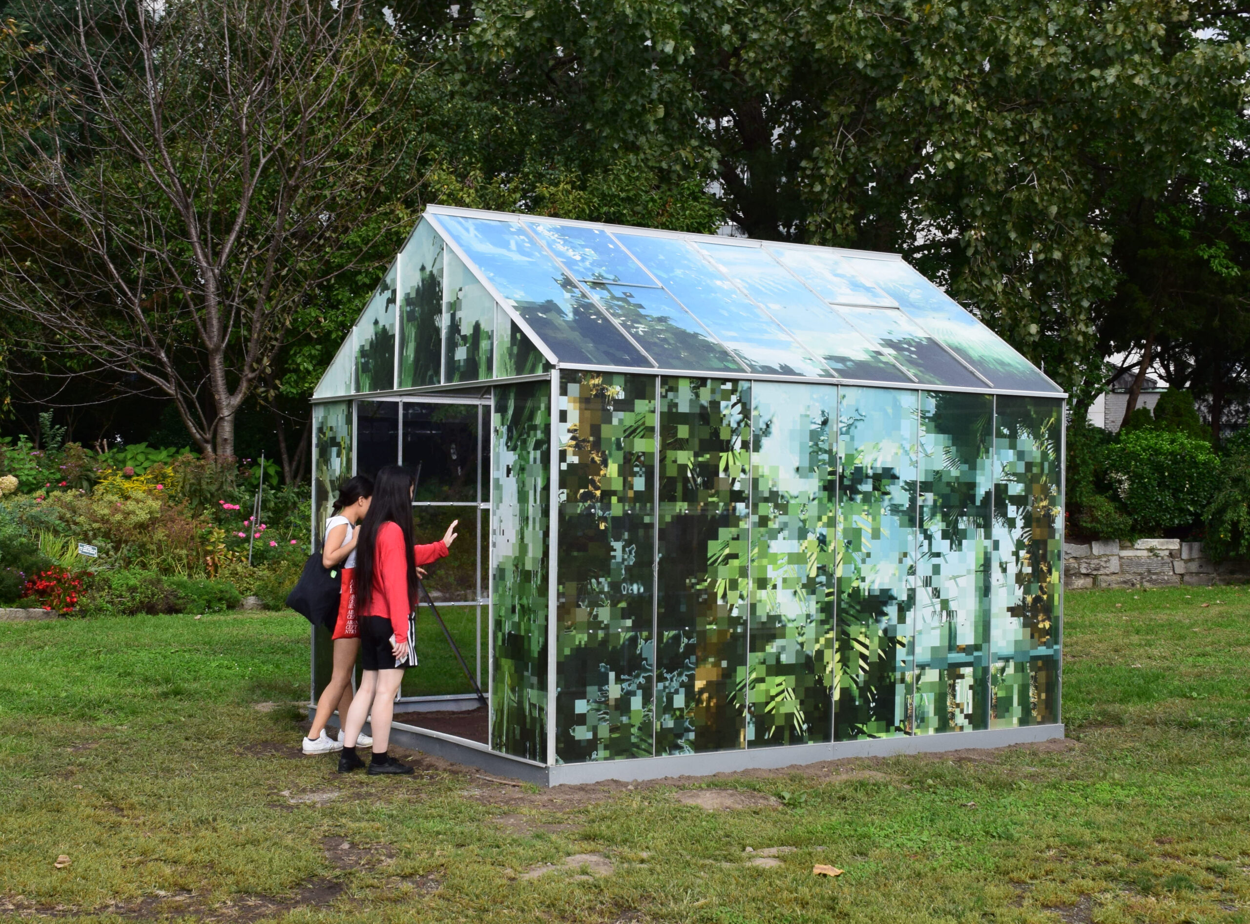 Joiri Minaya, Tropticon, 2018. Aluminum, polycarbonate sheets, one-way vision perforated vinyl, and wood, 144 x 192 x 120 inches. Photo by Scott Lynch, courtesy Socrates Sculpture Park.