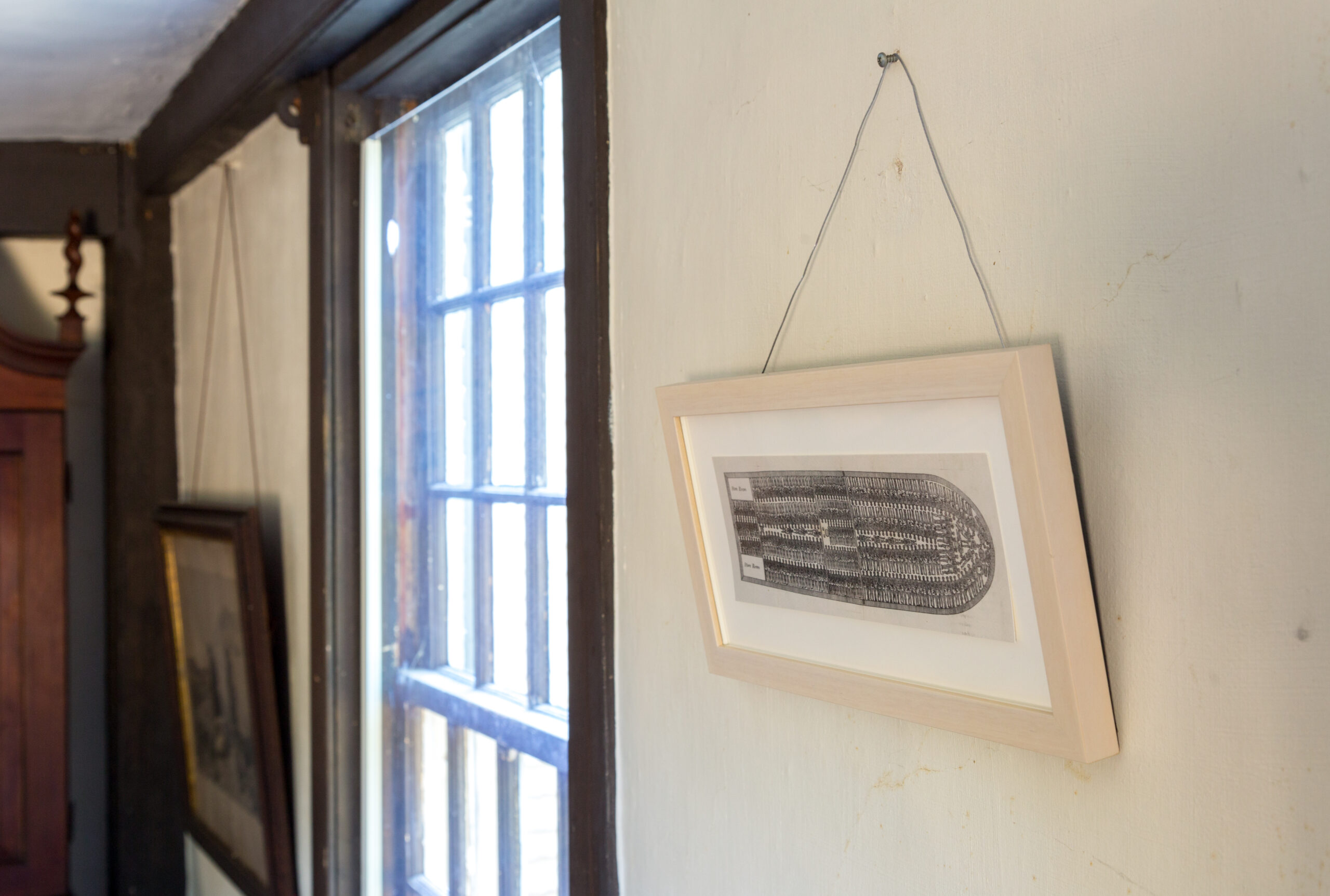 An image of a slave ship hangs on the wall of The Old Manse in Concord.