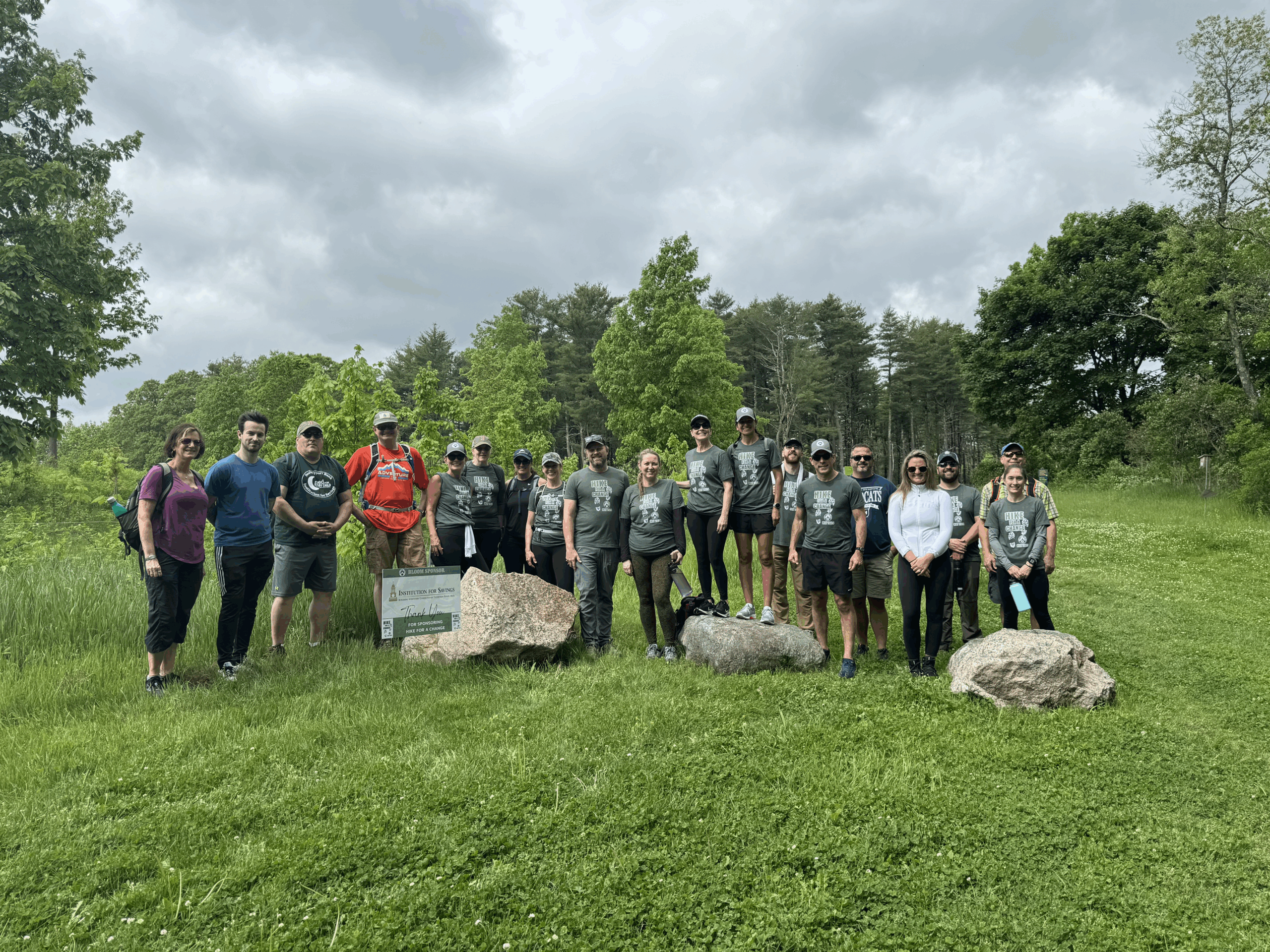 Participants in Hike for a Change smile at the camera in a green field.