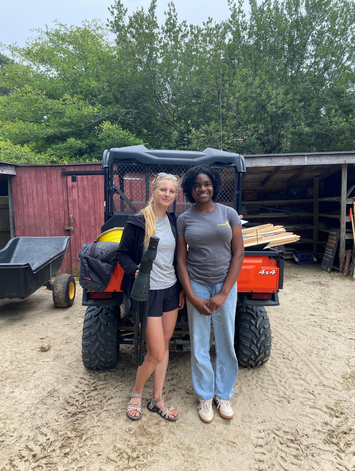 Two girls standing in front of a kaboda four-wheeler