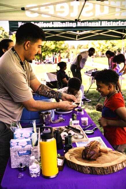 A man shows off an artifact to a young child