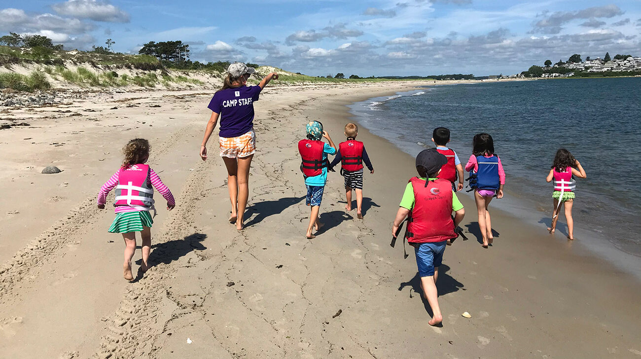 SumerQuest 2025 campers combing Crane Beach on the Crane Estate.