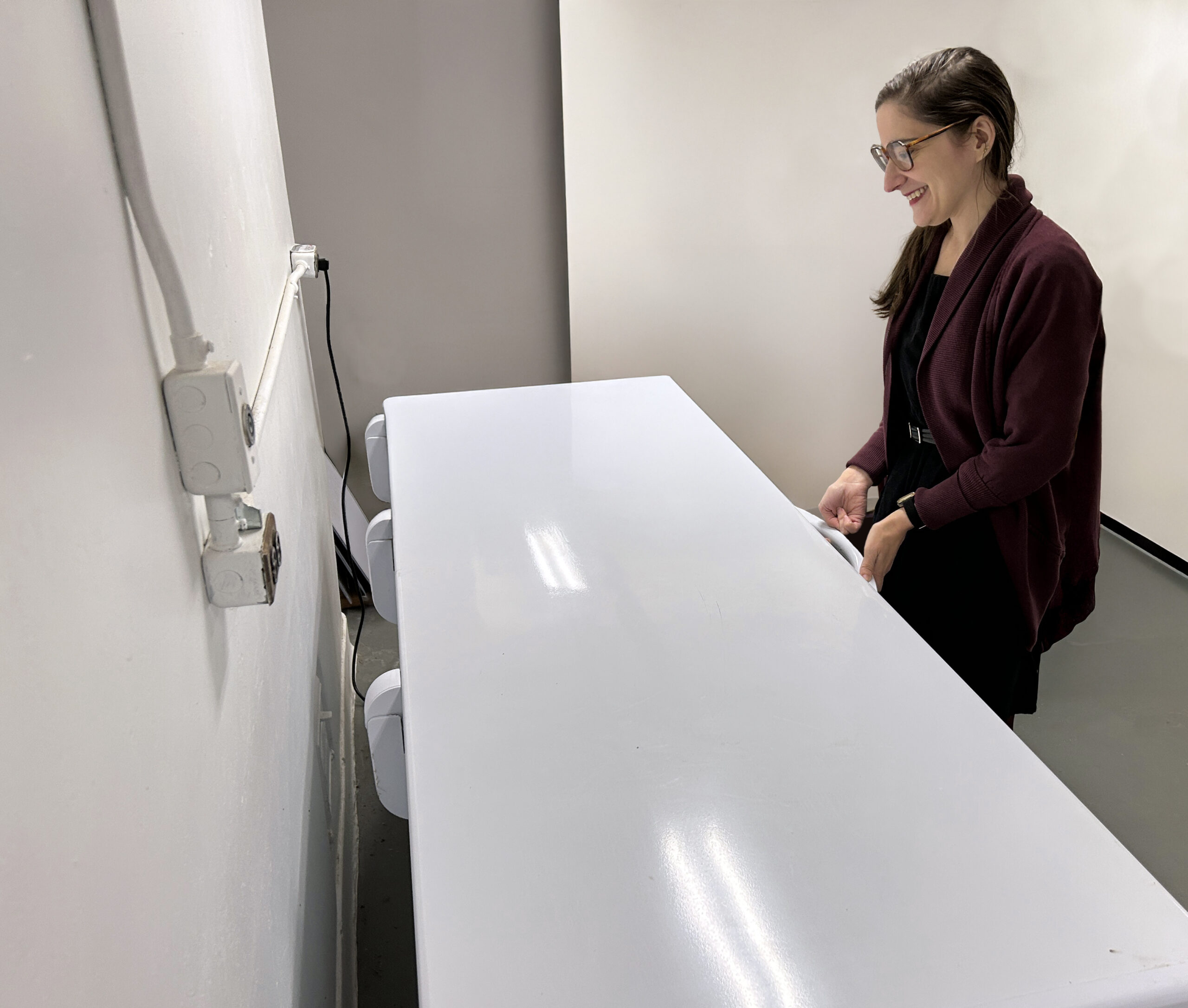 Trustees Collection Manager Anna Thompson opens a chest freezer in the basement of the Archives & Research Center which houses quarantined and delicate historical objects.