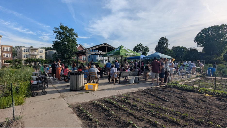 People gather at a community garden.