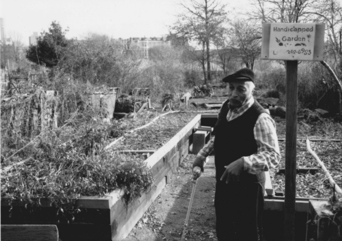 A man in a community garden (black and white).