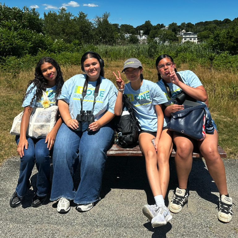 Four teens smile at the camera