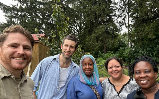 Five people smile at the camera