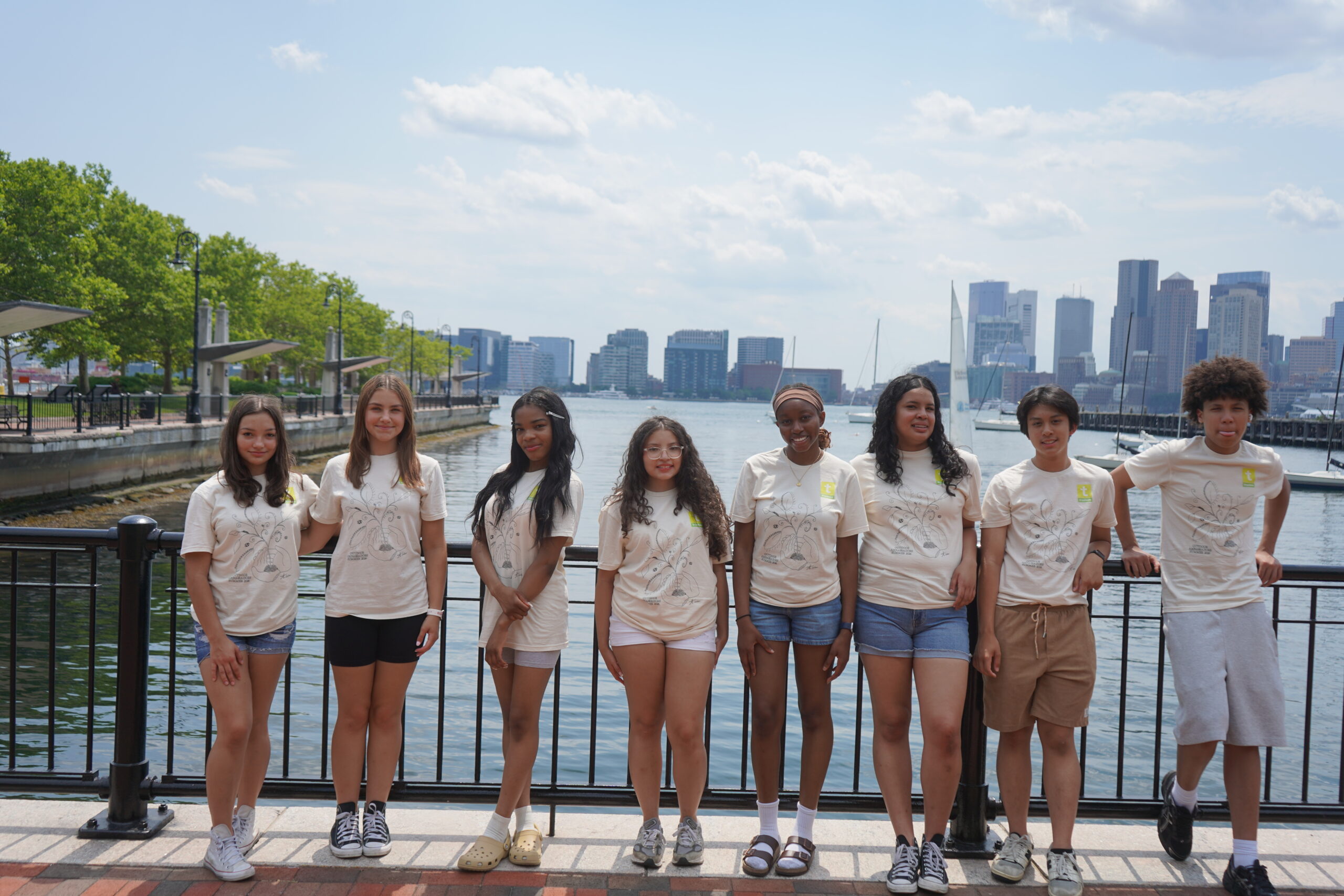 A group of teens with Boston in the background