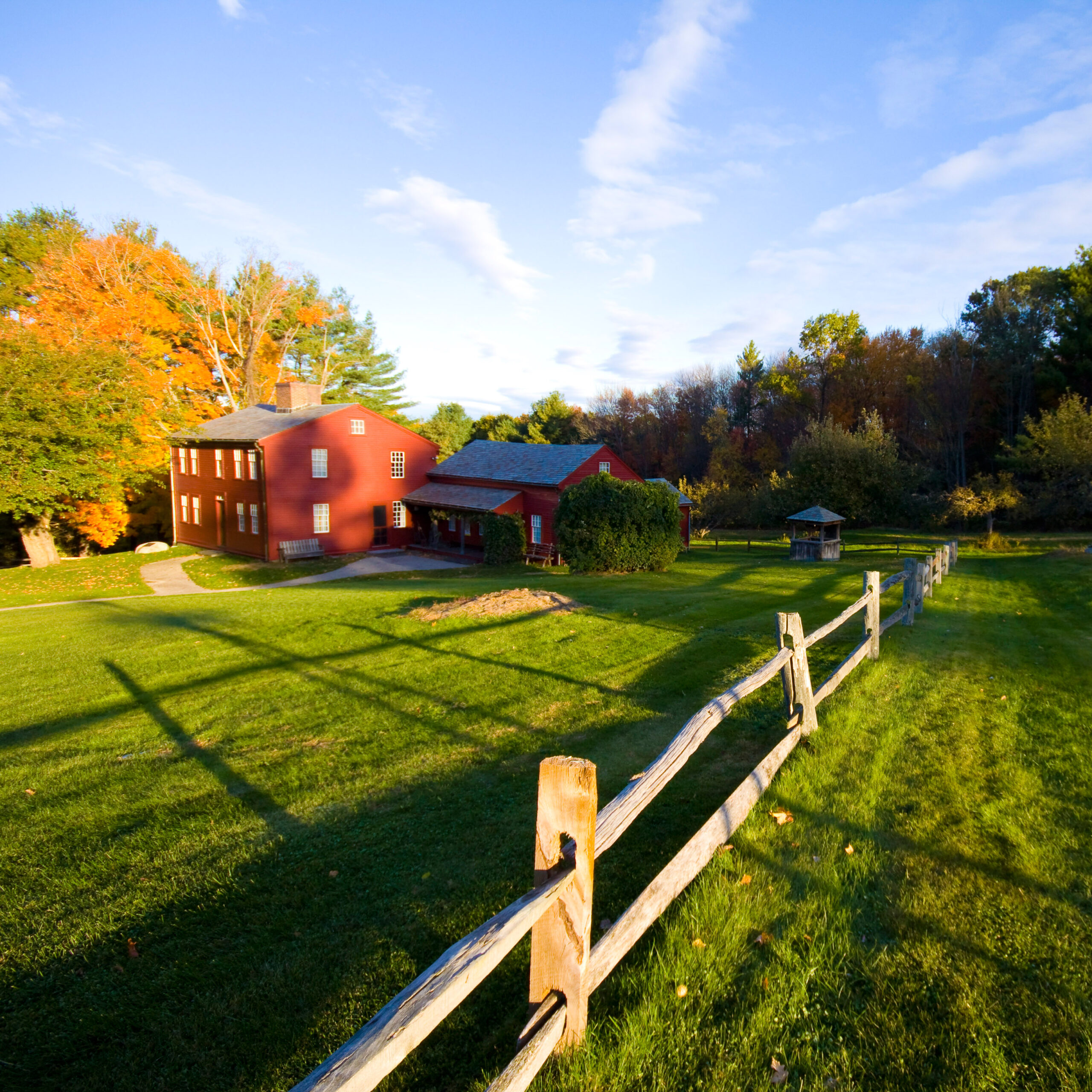 A red farmhouse in a green field
